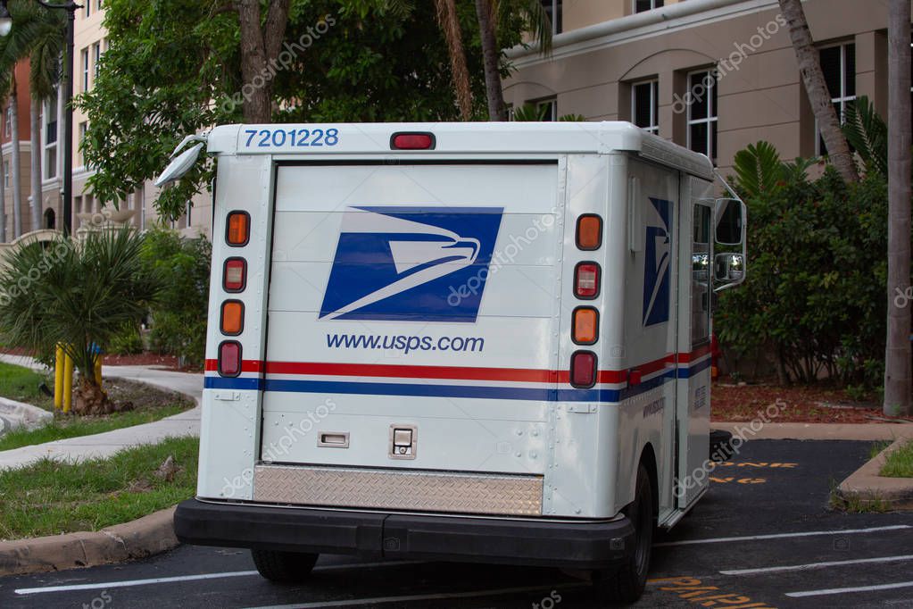 Miami, USA - August 6 2019: USPS car parked at the building, Sunny Isles Beach, Florida. USPS provides is a shipping and mailing service in the United States