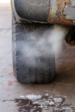 the toxic exhaust of a car badly spoils the environment clipart