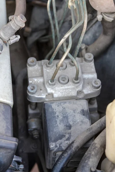 old ABS unit under the hood of the car