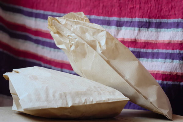 bags with rolls on a wooden surface on a fabric background