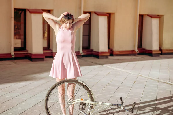 Девушка упала и сломала велосипед. эмоции испугались и не знают, что делать — стоковое фото