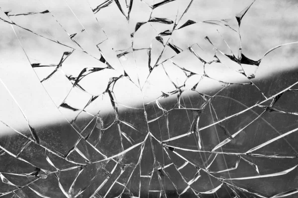 broken natural glass. dirty surface in cracks. black and white photography. texture