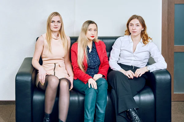 portrait of three women in the office on  sofa