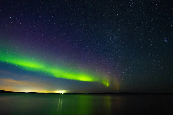 Beautiful  Northern Lights (polar lights, aurora borealis) in September (unique phenomenon) on the starry sky