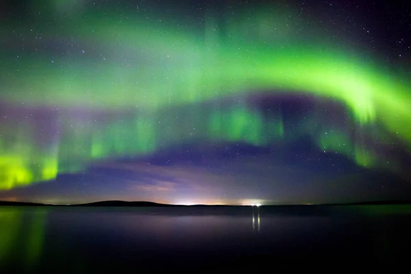 Beautiful  Northern Lights (polar lights, aurora borealis) in September (unique phenomenon) on the starry sky