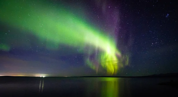 Beautiful  Northern Lights (polar lights, aurora borealis) in September (unique phenomenon) on the starry sky