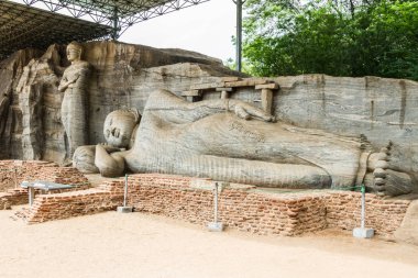 Sri Lanka, Polonnaruwa, The Palace Complex of King Parakramabahu. Gal Viharaya. Ancient Sinhalese rock temple with 4 Buddha statues, including 2 seated, 1 standing & 1 reclining clipart