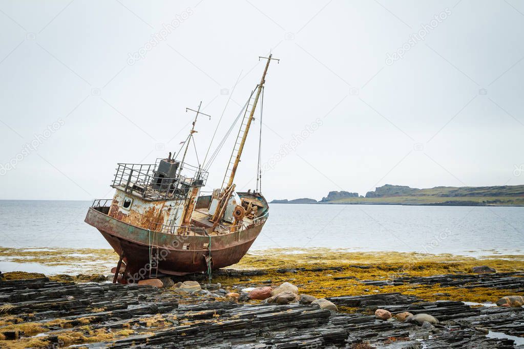 Abandoned ship on the coast of the Arctic Ocean.