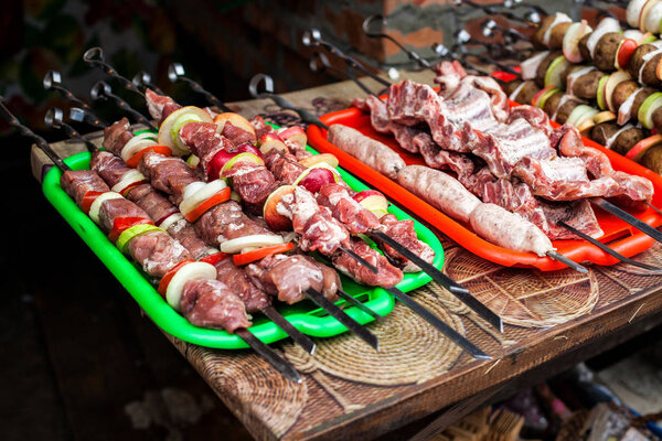Preparing meat and vegetables for barbecue grill 