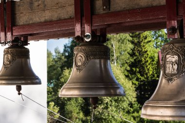 The bells have different tonality. Their melodic ringing is heard very far. Olonets, Karelia, Russia clipart