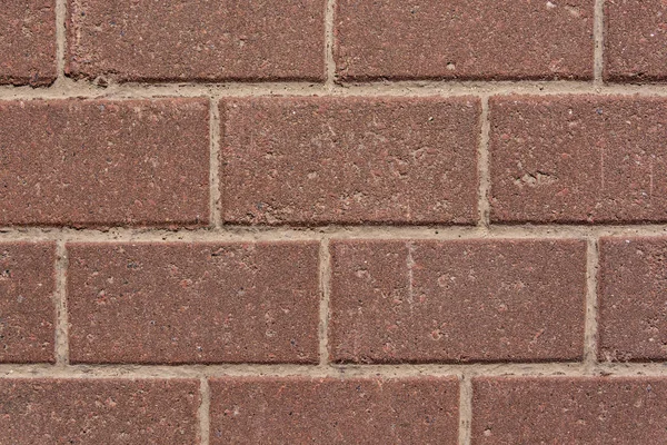 Mur av röd granit tegel — Stockfoto