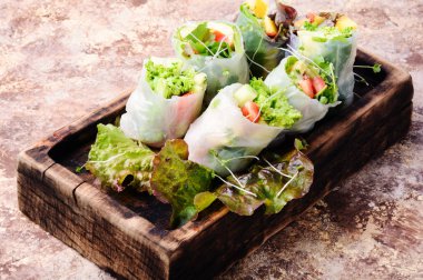 Assorted Asian spring rolls with vegetable and lettuce clipart