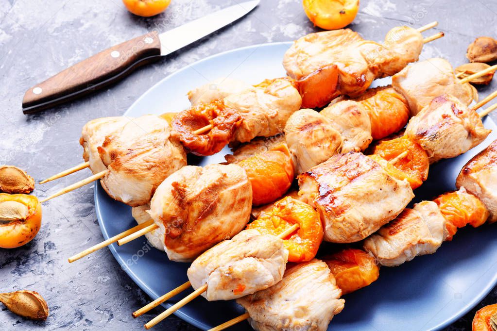 Turkey meat on barbecue grill,cooked on skewers with apricot .BBQFood for a picnic.