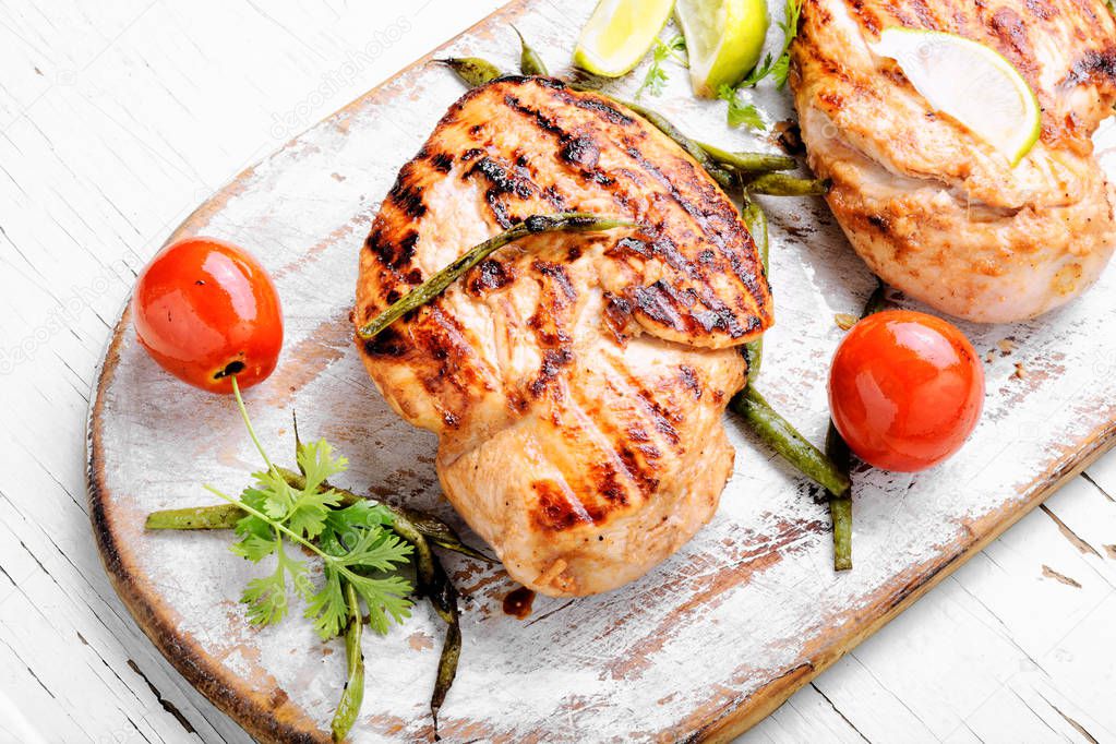 Whole chicken breast with spices on kitchen board.Healthy food