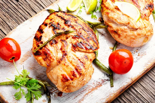Whole chicken breast with spices on kitchen board.Healthy food