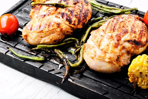 Grilled chicken fillets on wooden cutting board,.Summer BBQ