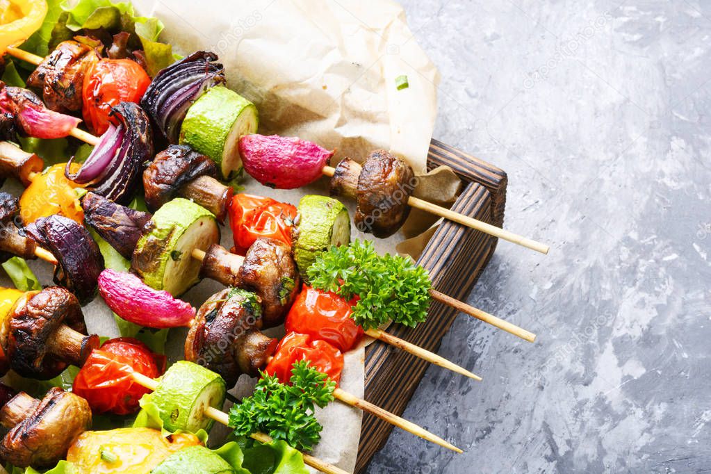 Grilled vegetable kebabs on skewers with tomato, pepper, mushrooms,zucchini and onion.Vegan diet.Vegetables kebab