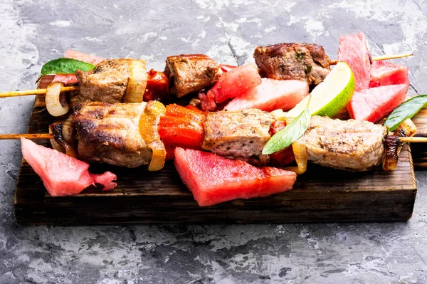 stock image Meat, shish kebab on skewers with watermelon.Eastern food