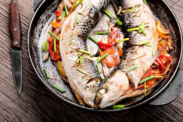 Baked sea fish stuffed with vegetables.Grilled delicious fish