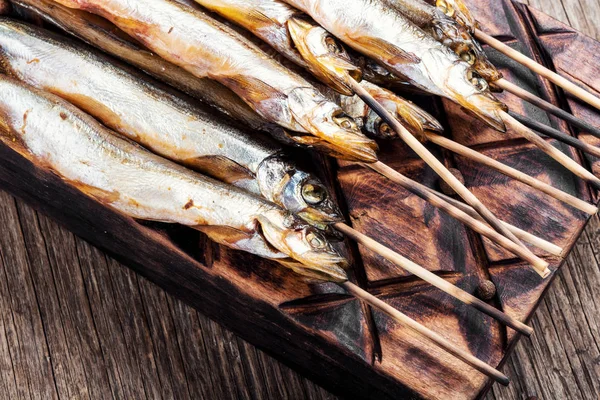 Smoked fish with spices.Cold smoked fish.Smoked capelin