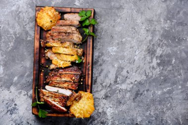 Kızarmış rosto et ananas ile ahşap kesme tahtası üzerinde dilimlenmiş. Üstten görünüm