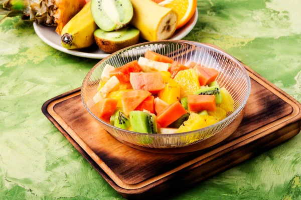 Fresh fruit salad on gray stone table.Colorful fruit salad