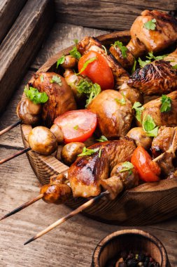 Meat chicken shish kebab with mushrooms and spices.Traditional Russian shashlik clipart