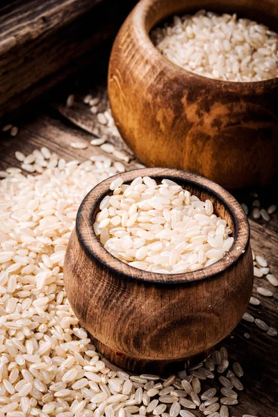 Uncooked dry rice in bowl.Rice in wooden bowl
