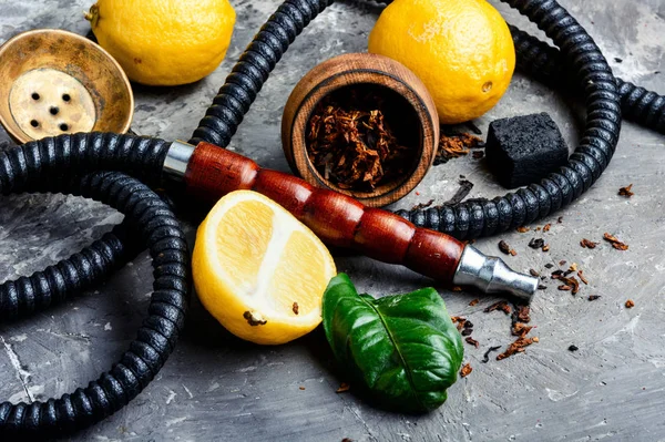 Smoking hookah with lemon flavor — Stock Photo, Image