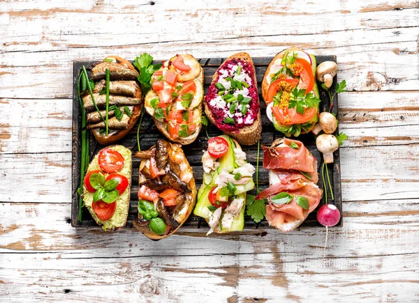 Bruschetta with various toppings — Stock Photo, Image