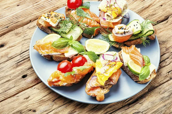 Assorted bruschetta with fish — Stock Photo, Image