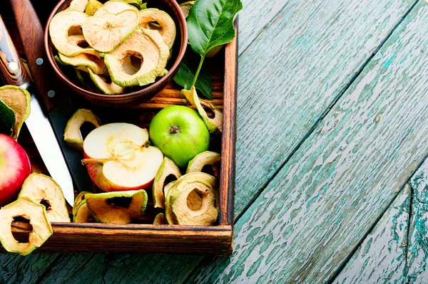 Sun-dried apple slices or apple chips and fresh apple