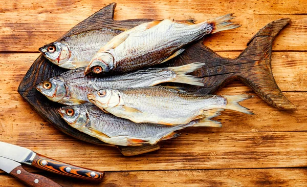 Sun dried fish,salted fish for beer on old wooden table