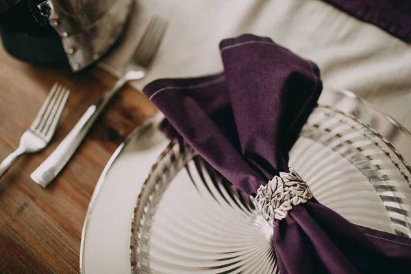 Purple napkin on a silver plate