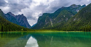 Lake Dobbiaco (Toblacher See, Lago di Dobbiaco) in Dolomite Alps, South Tirol, Italy - Travel destination in Europe clipart