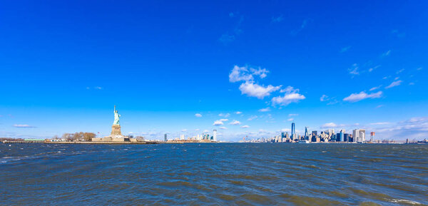 Panorama View of Statue of Liberty at New York City with Manhattan Skyline over Hudson River - USA