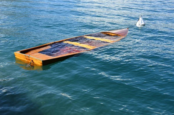 Boat anchored on lake near pier