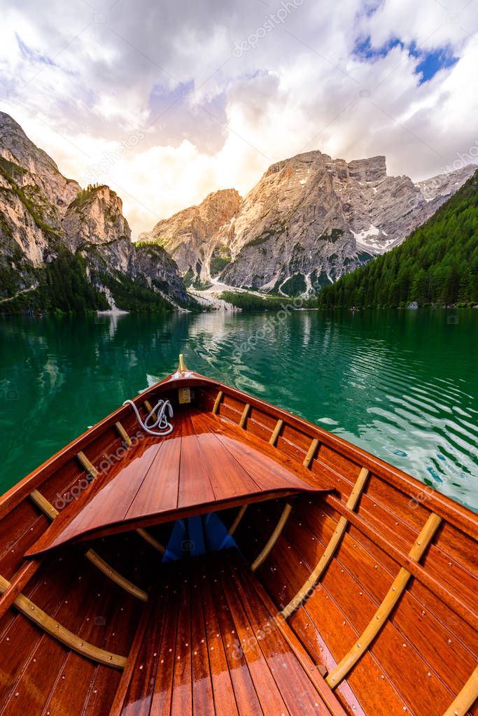 Lake Braies (also known as Pragser Wildsee or Lago di Braies) in Dolomites Mountains, Sudtirol, Italy. Romantic place with typical wooden boats on the alpine lake.  Hiking travel and adventure.