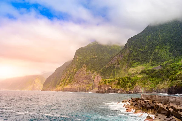 Beautiful wild coast scenery view with Bridal Veil Falls (Veu da noiva) at Ponta do Poiso in Madeira Island. Near Porto Moniz, View from Seixal, Portugal.