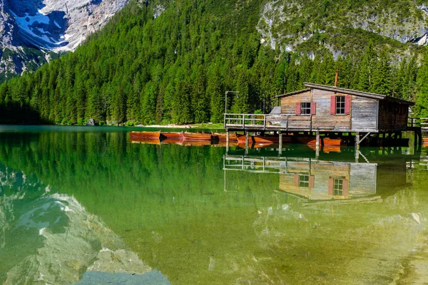 Wooden lake house at Lake Braies also known as Pragser Wildsee  in beautiful mountain scenery. Amazing Travel destination Lago di Braies in Dolomites, South Tyrol, Italy, Europe.