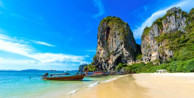 Ao Phra Nang Plajı 'ndaki kireçtaşı karst, Tayland geleneksel ahşap uzun kuyruklu teknesi ile Ao Nang, Krabi, Andaman Denizi, Tayland yakınlarında.