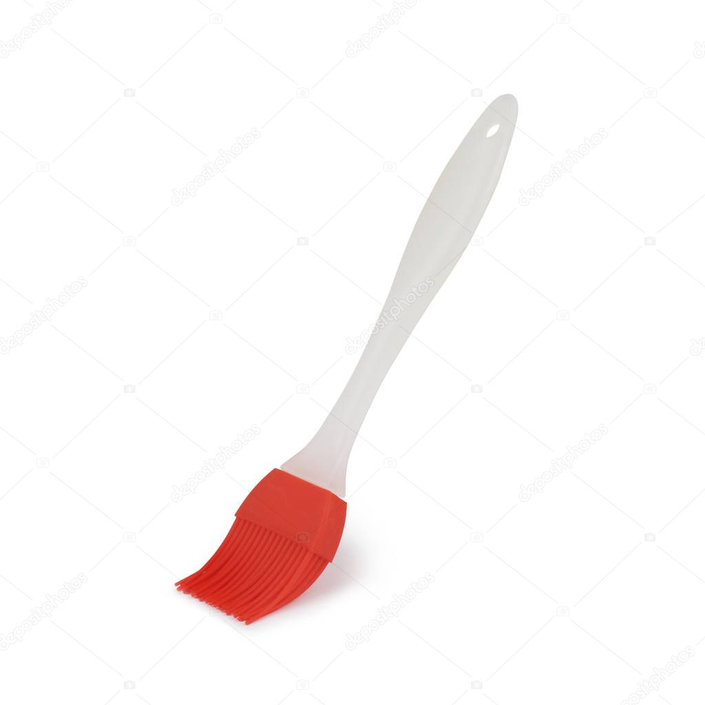 Silicone brush for baking on white background, shadow below.