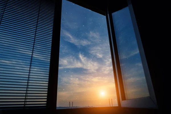 Sunset sky with stars - view from window.