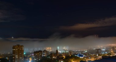 Vladivostok şehir manzarası gece manzarası. Şehrin üzerinde sis var..