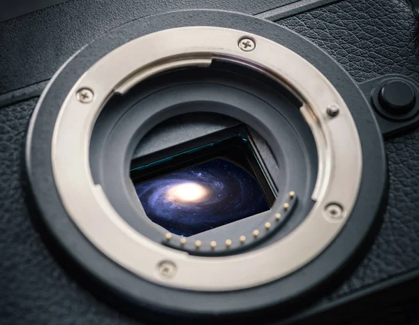 Sensor of a mirrorless camera with galaxy. Concept photo.