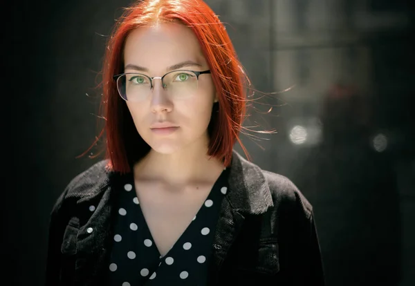 Portrait of beautiful redhead woman wearing glasses.