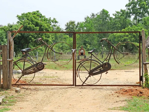 bicycles fit into a gate in Auroville