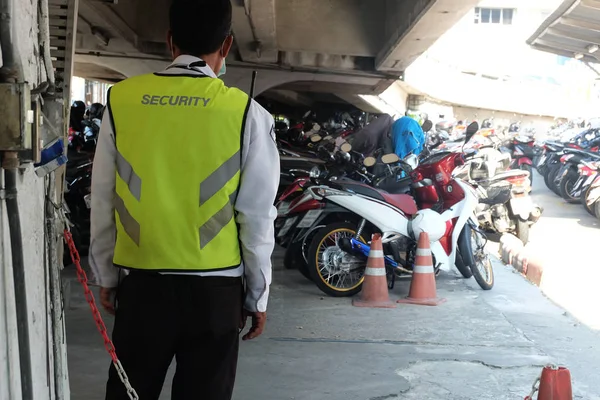 Security guard surveillance at motorcycle parking of building or shopping mall