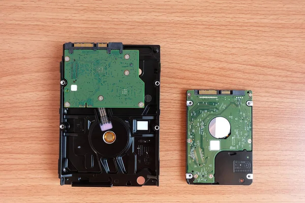 Internal Hard Disk Drive two sizes for Desktop and Laptop computer on wooden floor