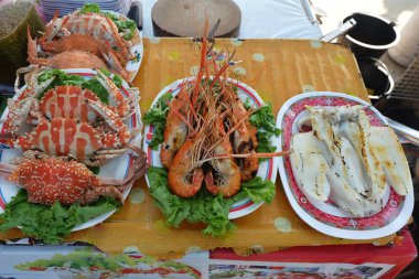 Buğulanmış bok, ızgara karides ve kızarmış kalamar ve plaka üzerinde ızgara kalamar. Satılık Deniz ürünleri görüntüleme